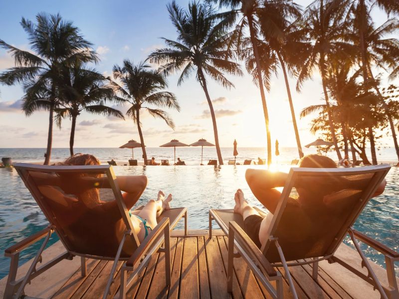 two people relaxing by the hotel pool