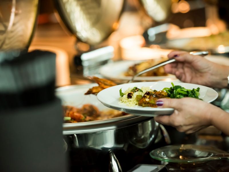 women serving herself at an all inclusive buffet